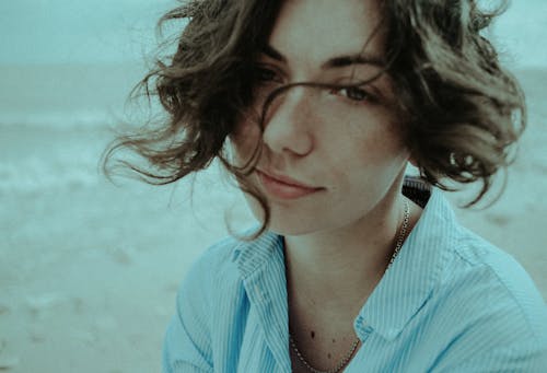 Woman in Blue and White Striped Button Up Shirt