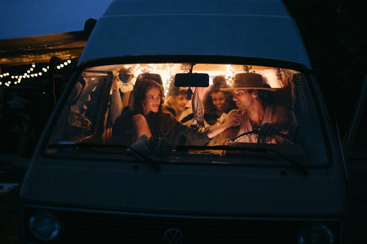 People Sitting Inside A Van During Night Time