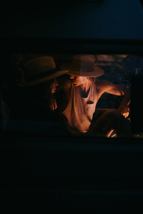 Man and Woman Camping Inside a Van