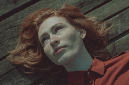 A Woman Lying on a Wooden Surface