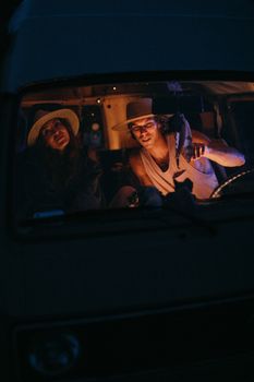 Couple enjoying a night drive in a van, embracing travel and adventure.