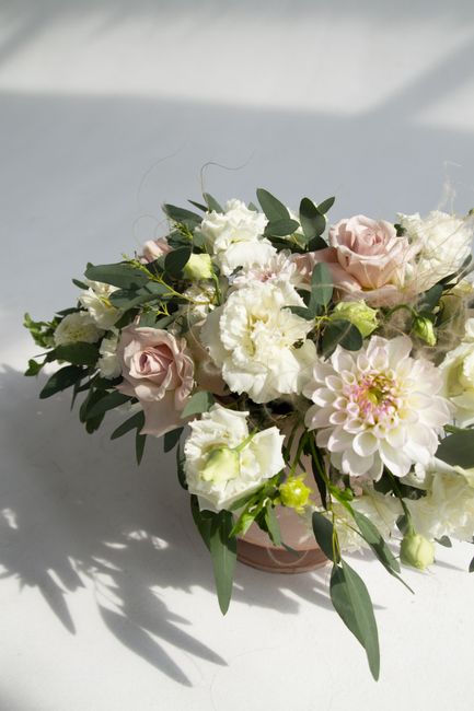 Beautiful floral composition featuring soft pink roses and white dahlias in natural light.