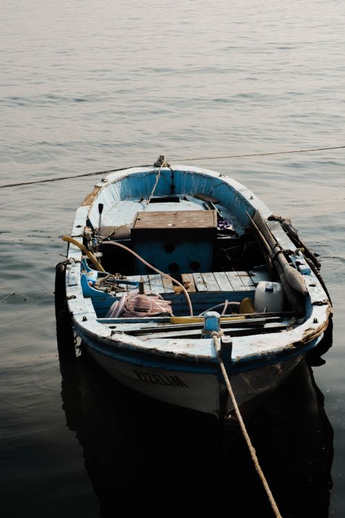 Free A rustic fishing boat docked in İstanbul's calm waters, ideal scene for travel themes. Stock Photo
