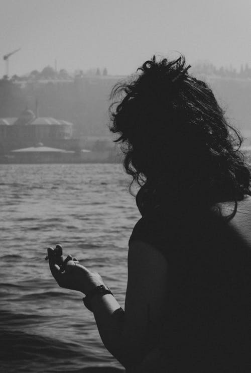 Woman Holding a Cigarette on Seaside