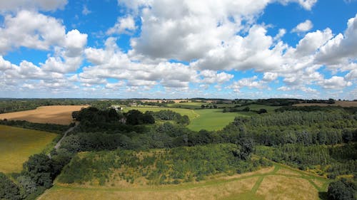 An Aerial Shot of Fields in the Countryside under a Cloudy Sky