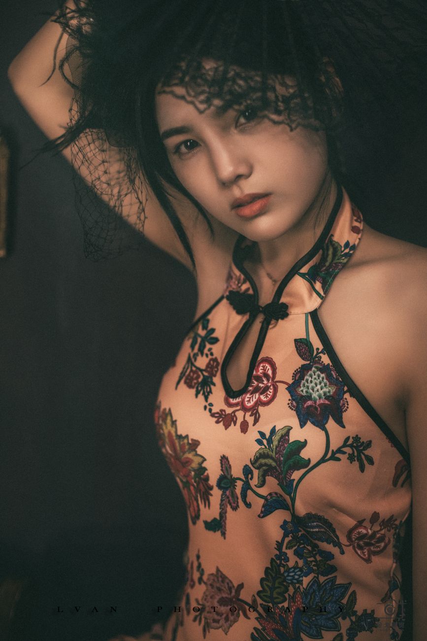 Stunning portrait of a woman in a traditional embroidered dress with a dramatic veil.