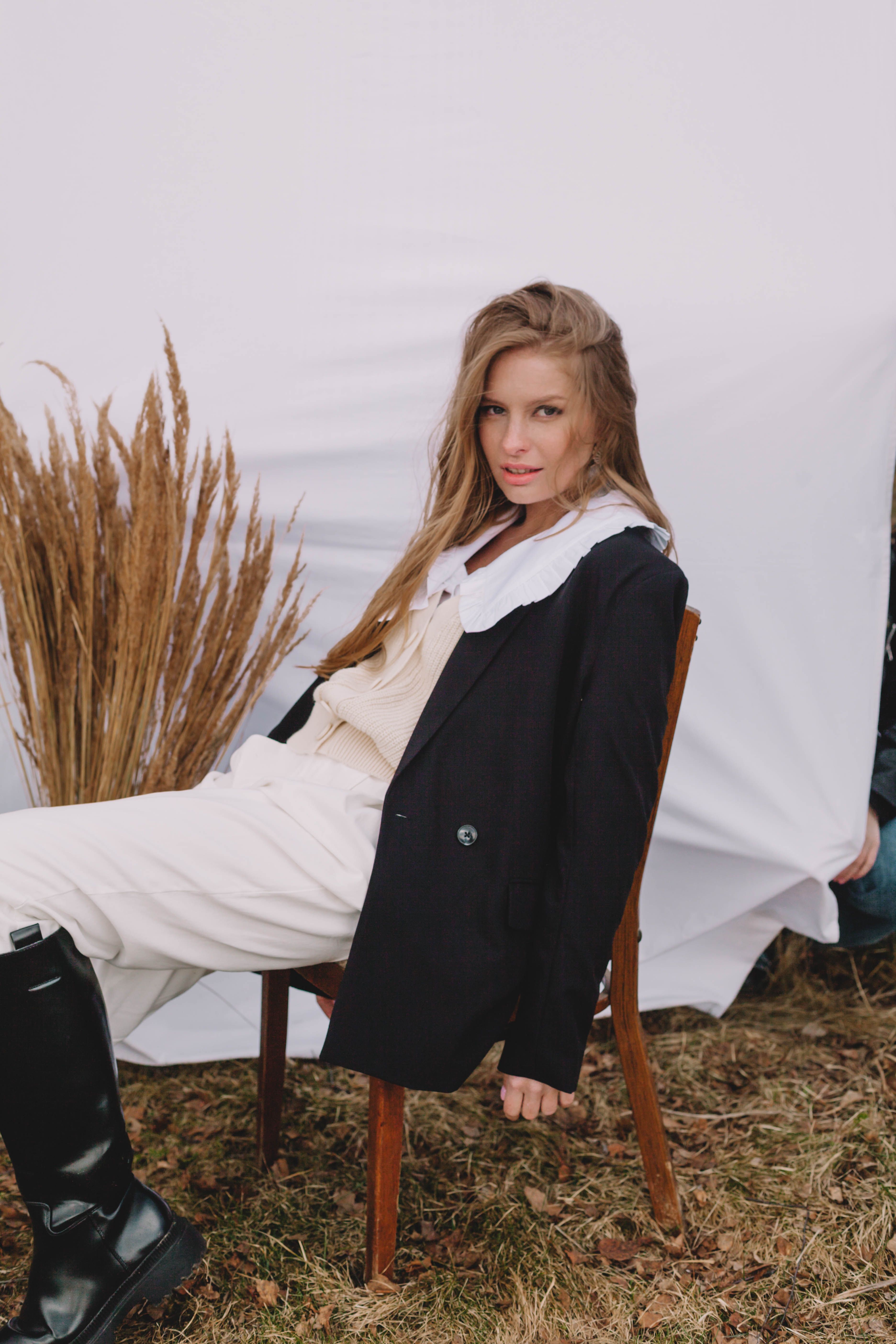 Woman in Black Blazer Sitting On a Wooden Chair · Free Stock Photo