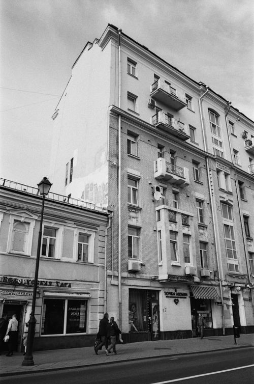 Free A grayscale photo capturing a city street with historic architecture and pedestrians. Stock Photo