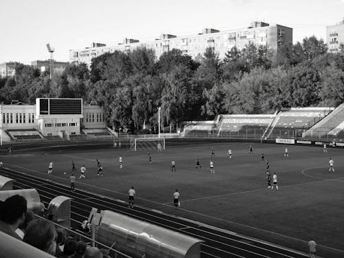 A Grayscale of Players Playing Soccer