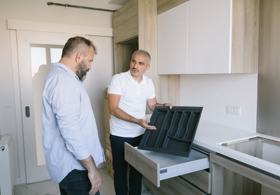 Man in White Polo Showing Drawer for Kitchen Utensils
