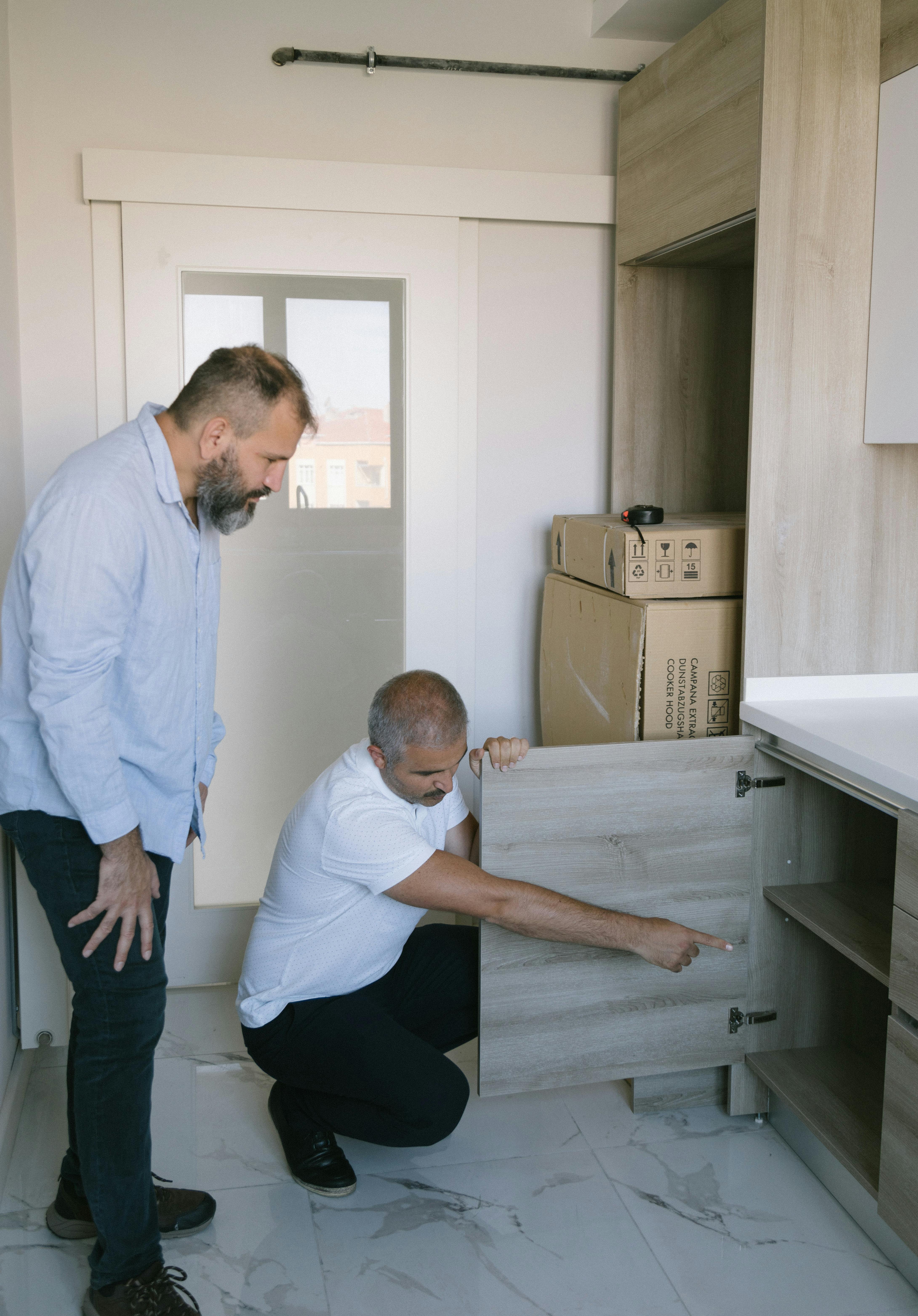 a man pointing inside a cabinet