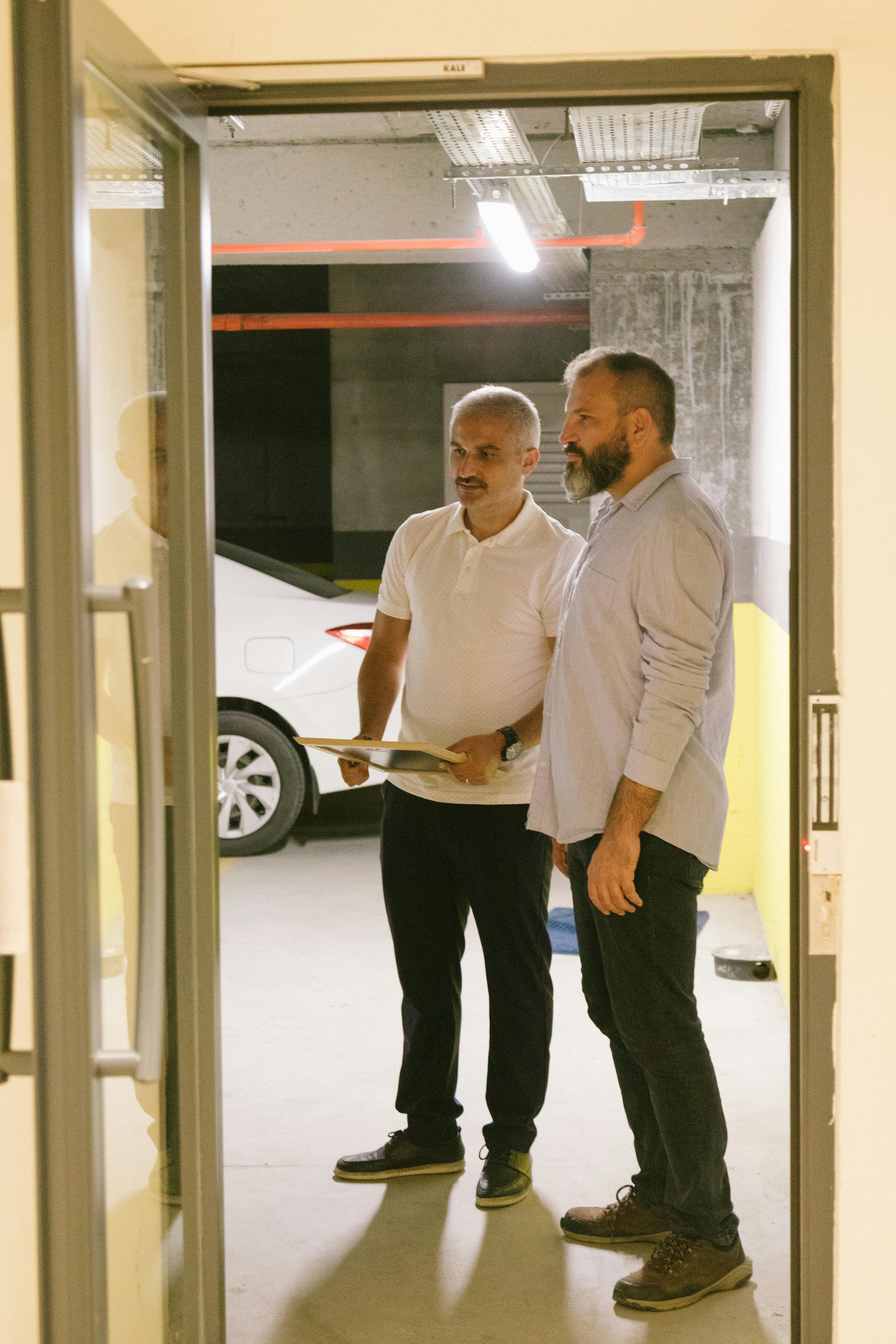 men standing near an open door while looking afar