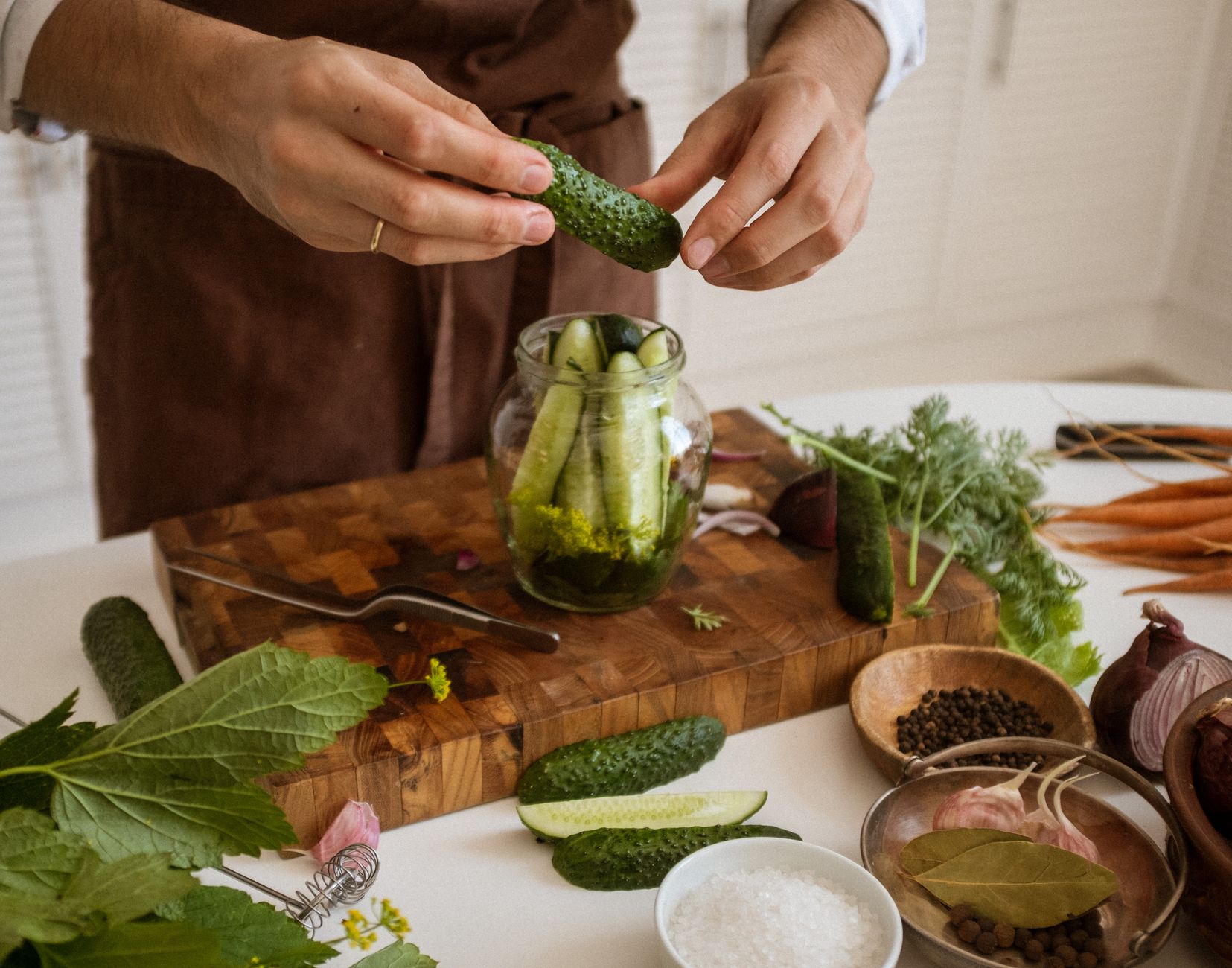 Crispy golden fried pickles with dipping sauce on a rustic wooden table