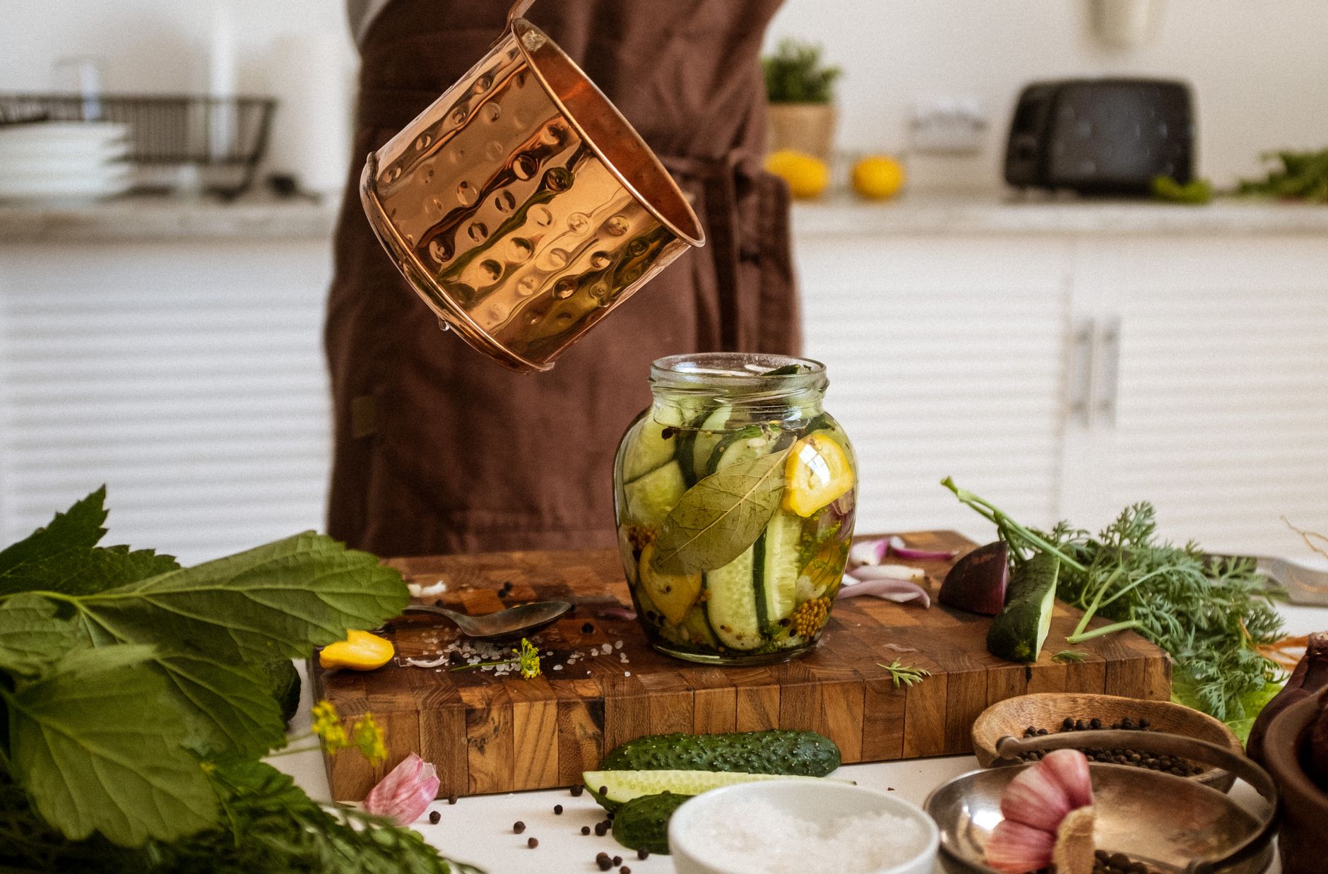 Glass jar filled with vibrant marinated vegetables layer