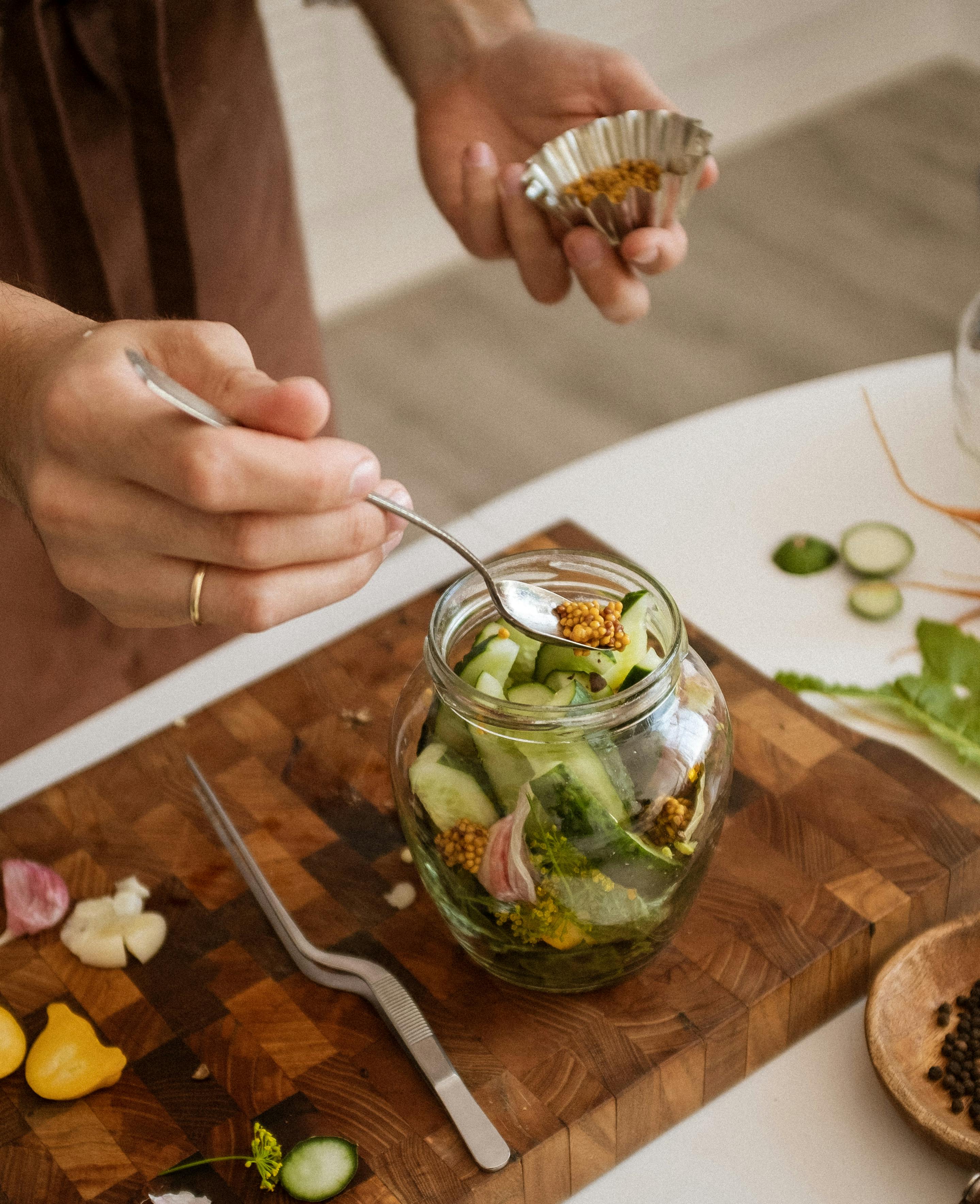 person holding a silver spoon with chickpeas