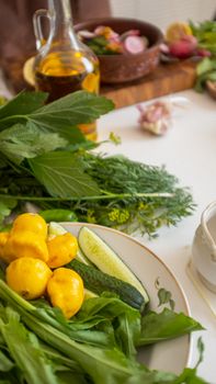 A vibrant selection of fresh vegetables and herbs captured on a kitchen table with a rustic touch.