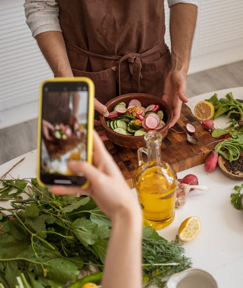 Free Person Holding a Bowl with Sliced Vegetables Stock Photo