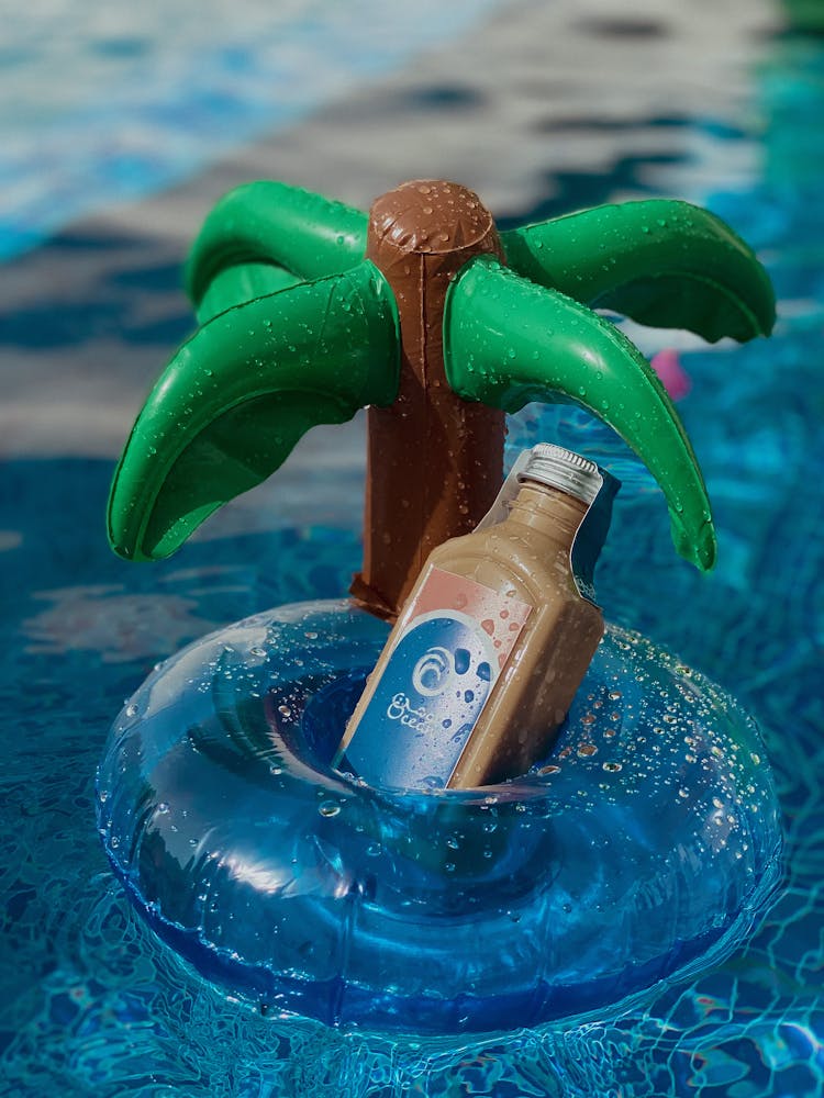 A Close-Up Shot Of A Bottled Coffee On An Inflatable Floater