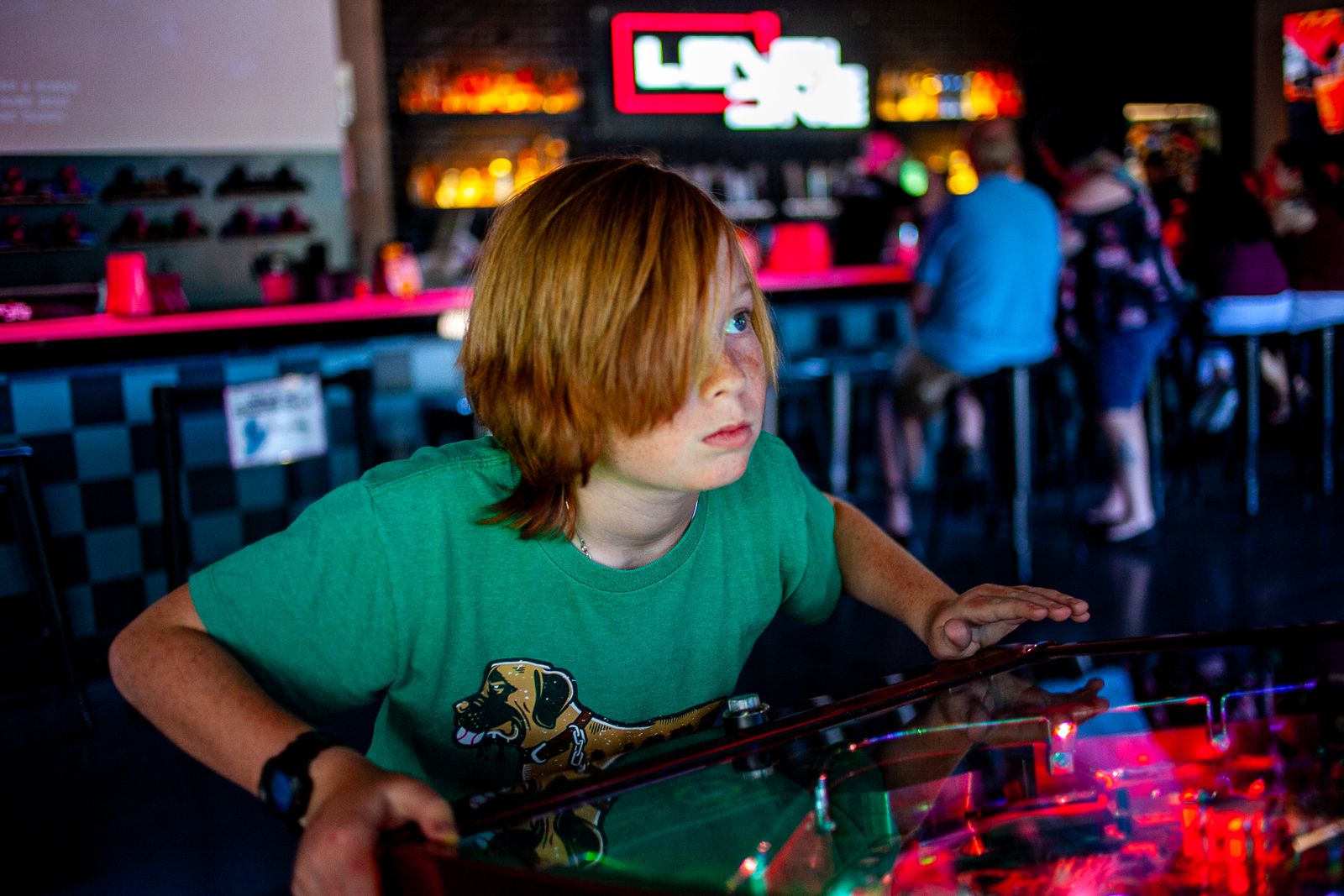 Kid playing an arcade machine