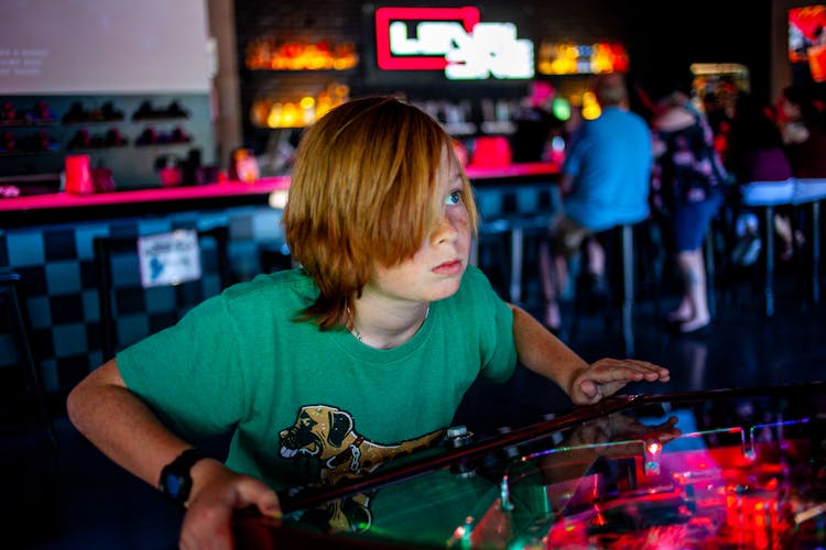 Child Playing An Arcade