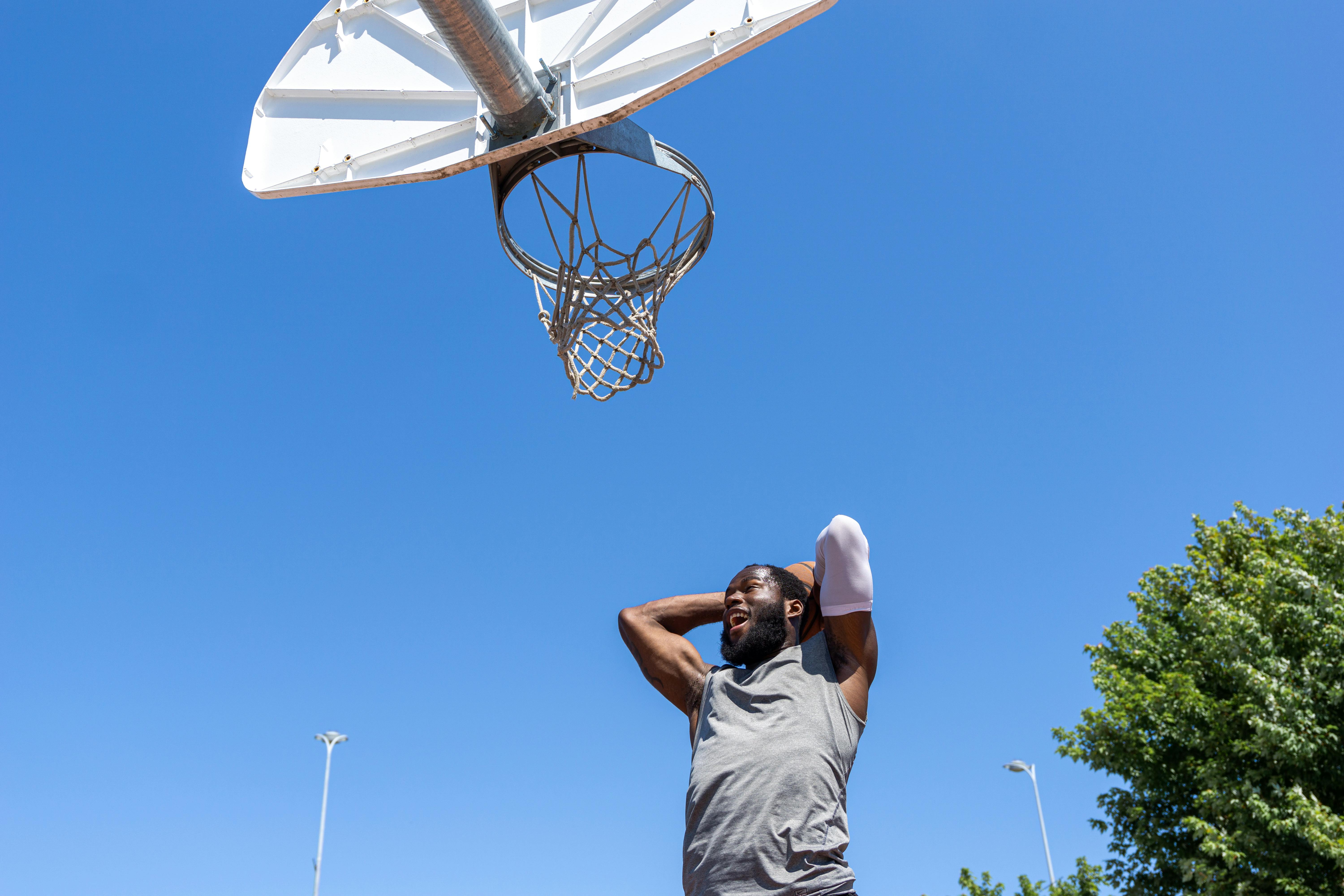 people playing basketball outside dunking