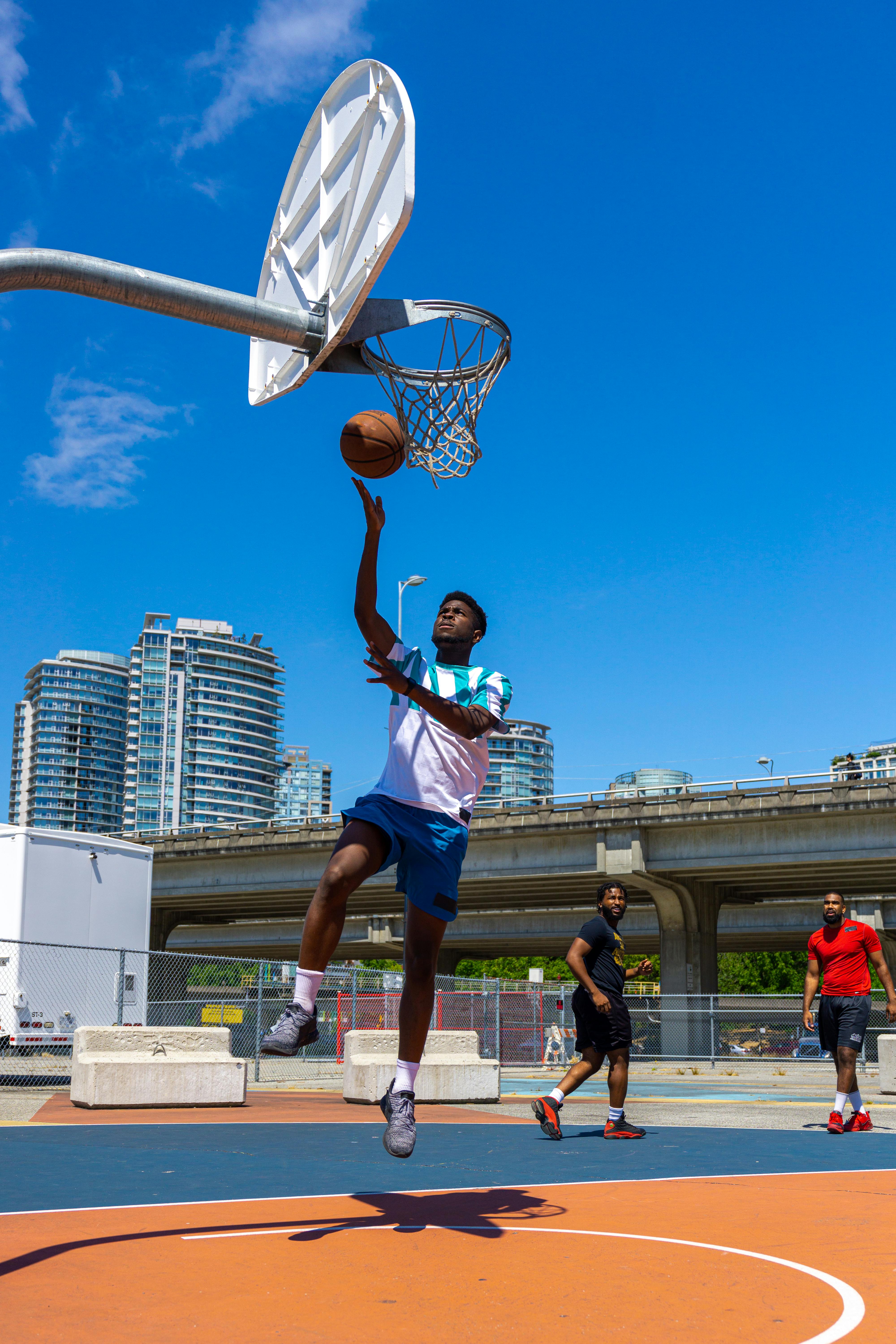 man shooting a basketball