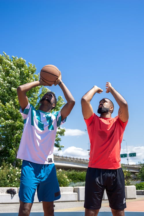 Men Practicing Shooting a Basketball