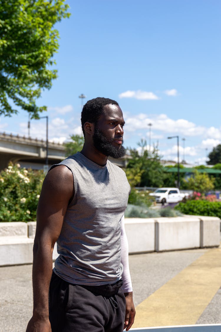 A Bearded Man In Gray Sleeveless Shirt