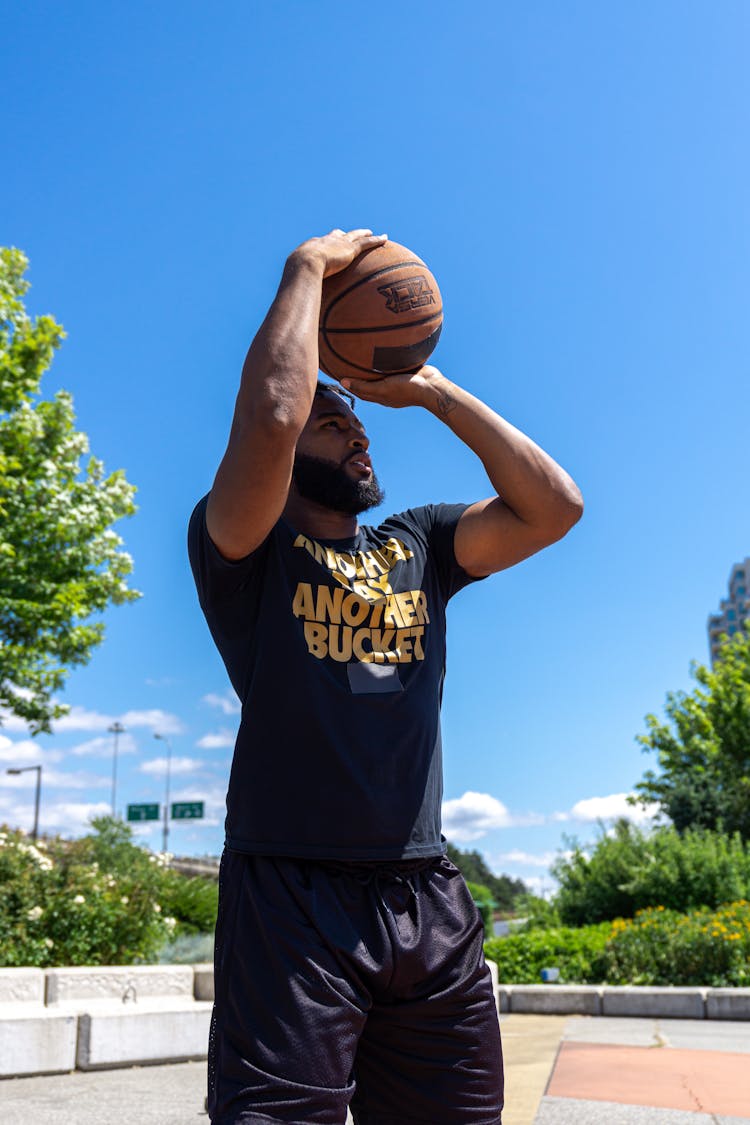 Left Handed Man Shooting A Basketball