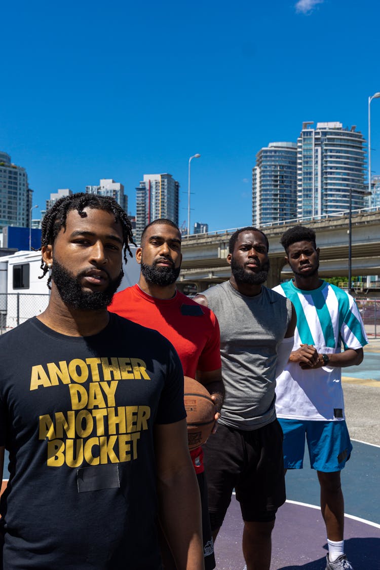 Group Of Men Standing In The Basketball Court 