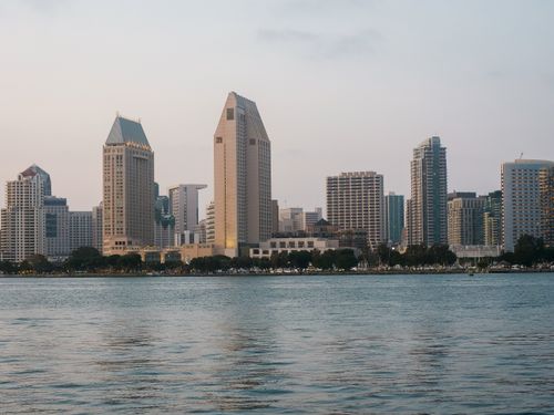 Free Cityscape of San Diego's skyline reflecting over the calm waters in the evening light. Stock Photo
