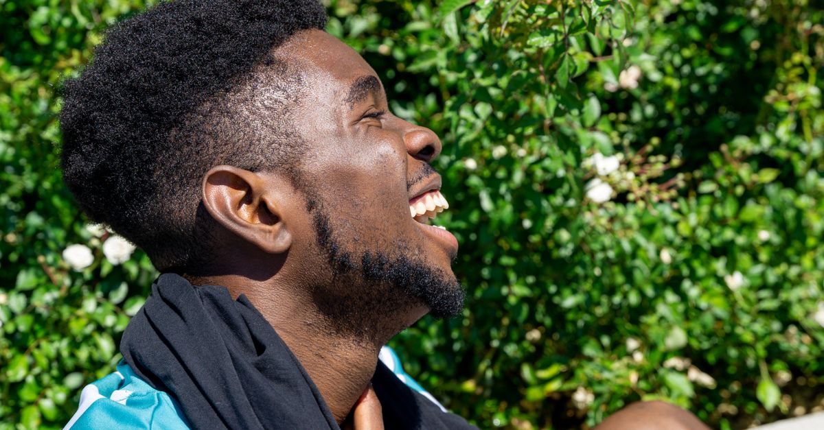 man laughing outdoors