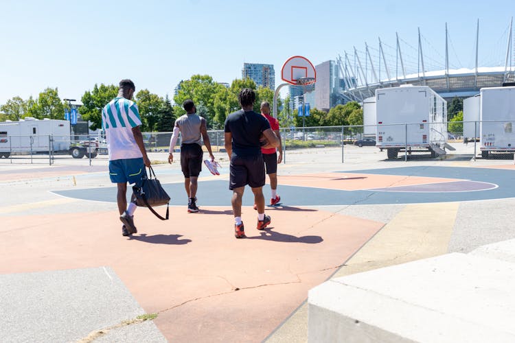 Group Of Friends In Activewear Walking Towards The Basketball Court