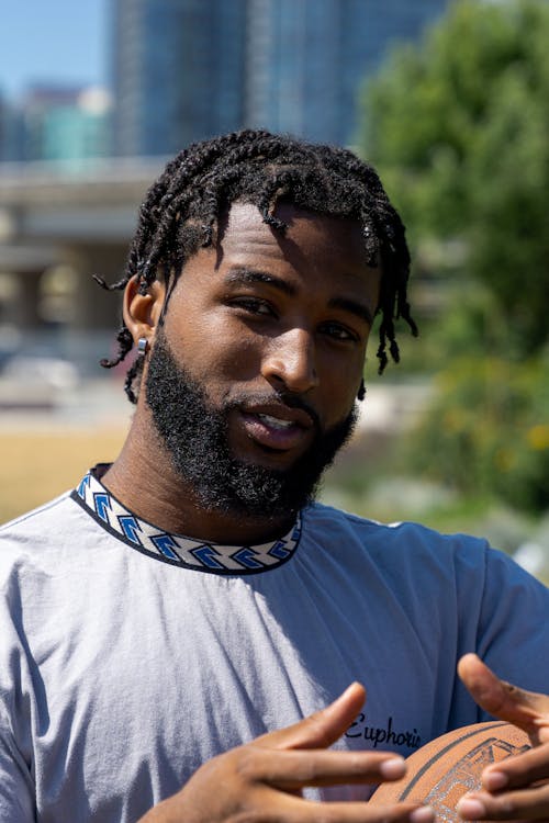 Bearded Man in Gray Shirt Looking at Camera