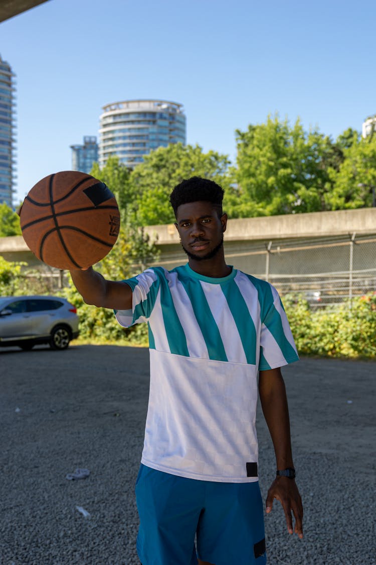 Man In Activewear Holding A Basketball While Looking At Camera