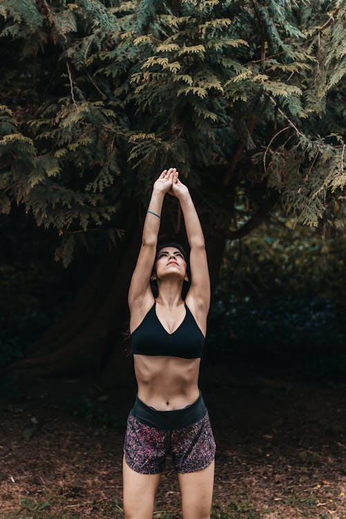 Woman in Black Brassiere Stretching Her Arms