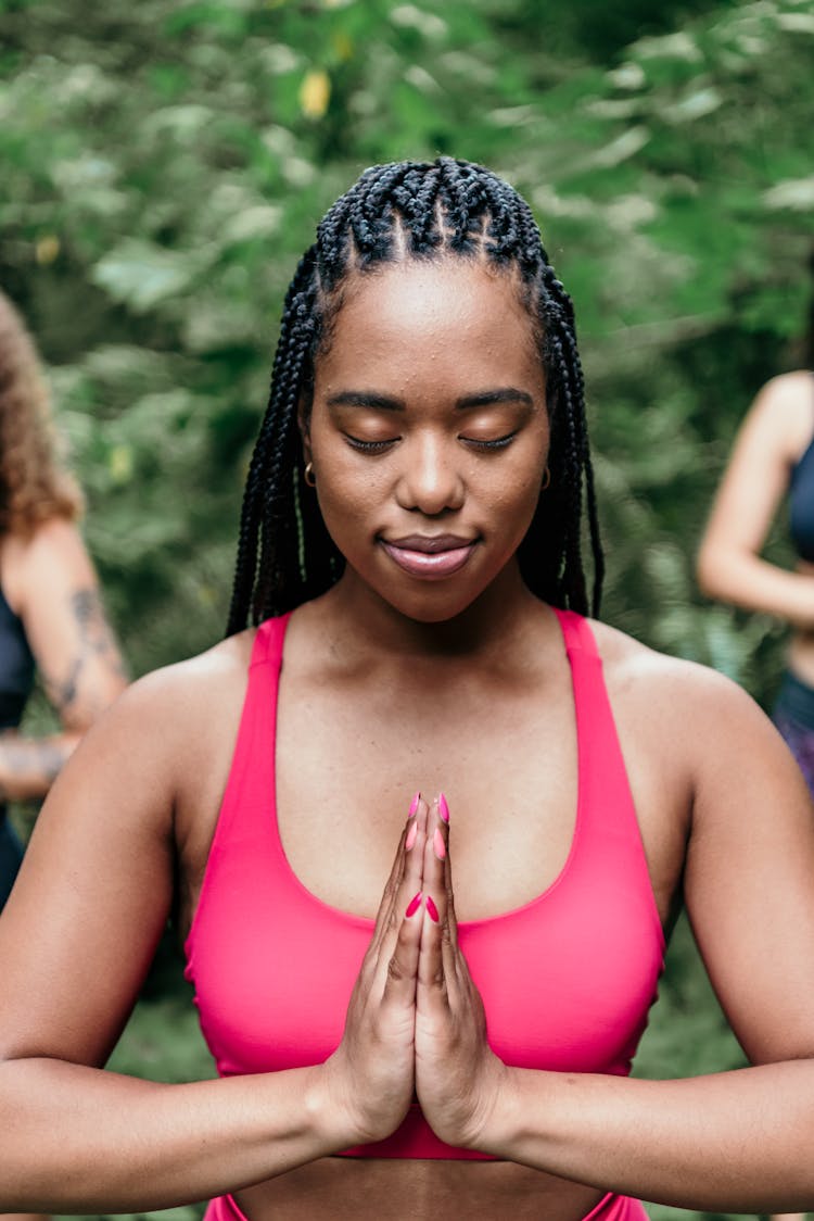 Woman In Red Activewear Meditating