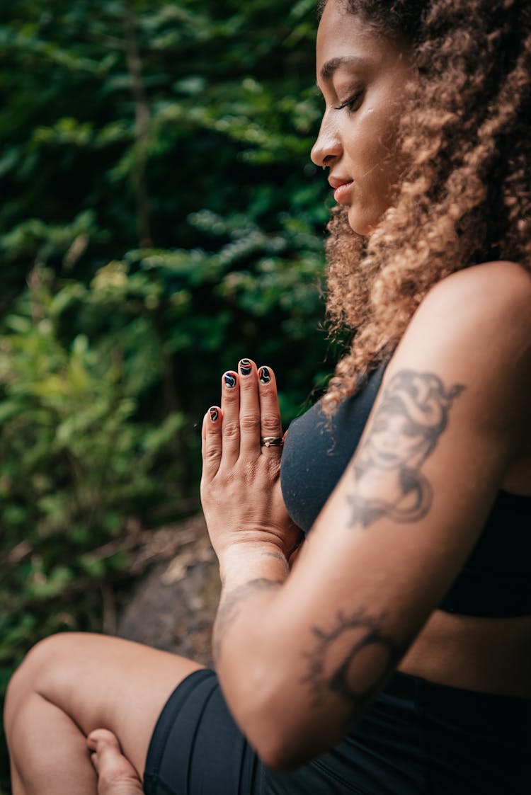 Woman In Black Activewear Meditating Outdoors