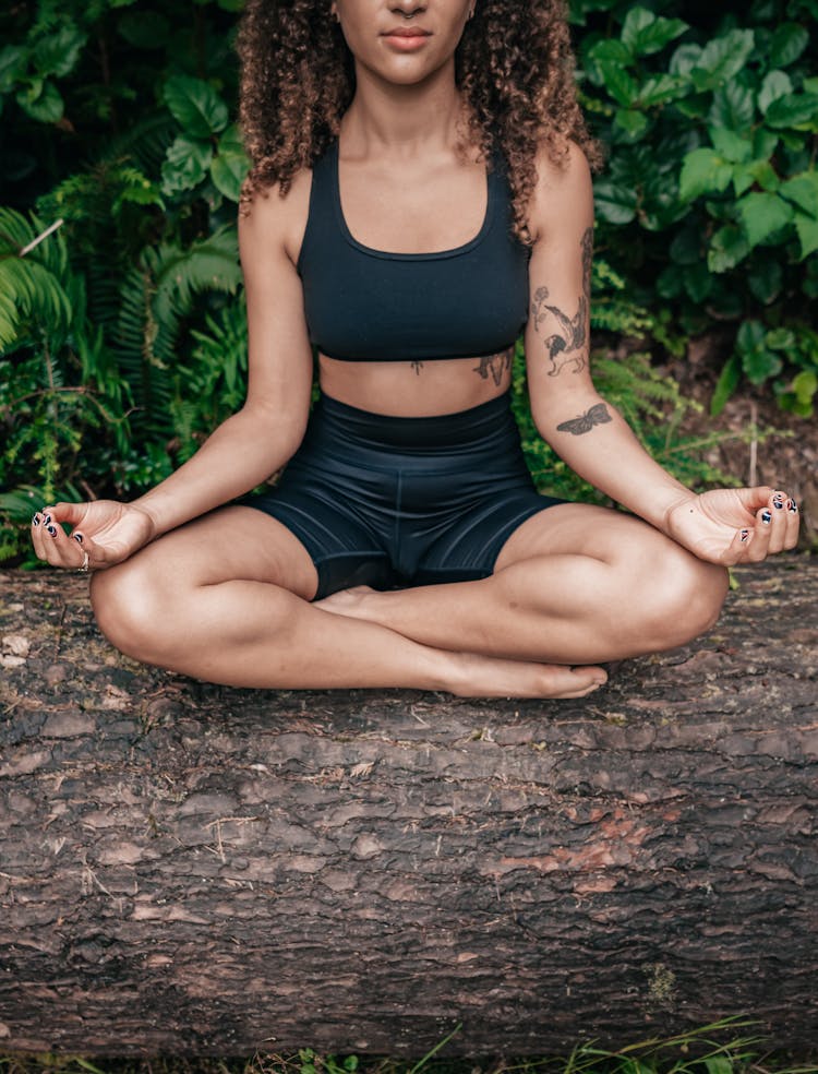 Woman In Black Activewear Meditating Outdoors