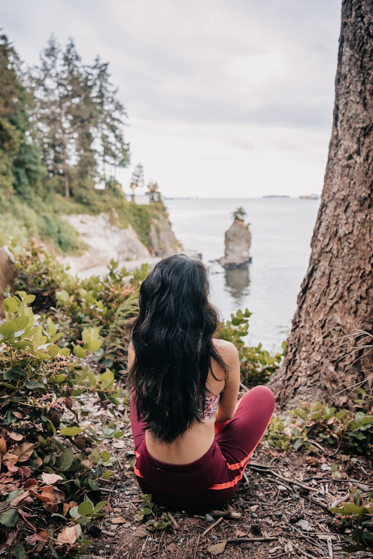 Back View Of A Person Sitting On The Ground