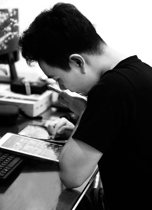 Free Man in Black T-shirt Using Laptop Computer Stock Photo