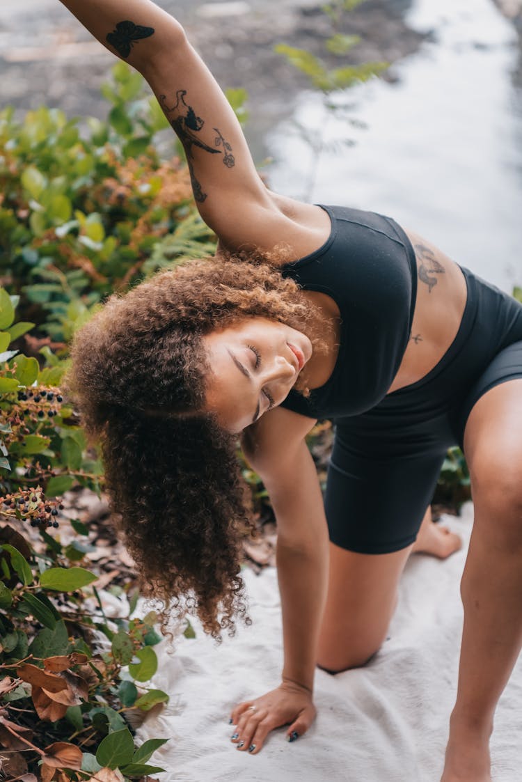 Woman In Black Activewear Exercising Outdoors