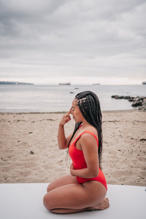 Woman Red Swimsuit Meditation on the Beach