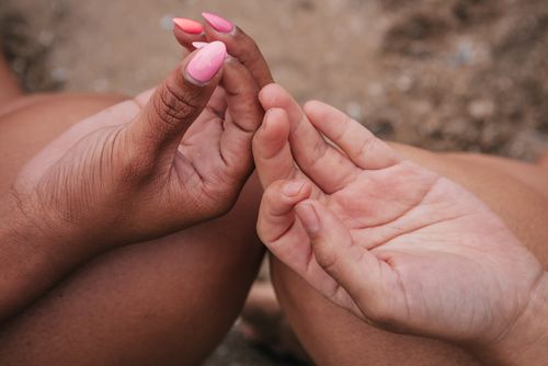 Free Close-up of hands in a meditative gyan mudra gesture against a natural backdrop. Stock Photo