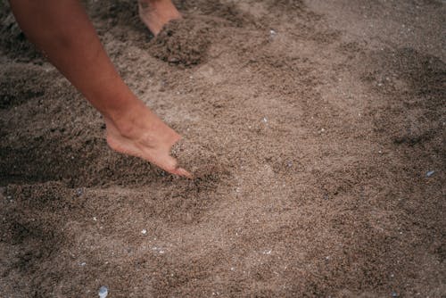 Free Persons Foot on Brown Sand Stock Photo
