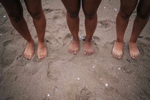 Free People Standing on Brown Sand Stock Photo