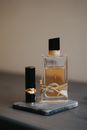 Clear Glass Perfume Bottle on Black Table