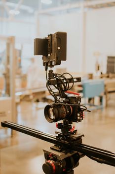 Close-up of a professional camera rig setup on a tripod in a modern studio setting.