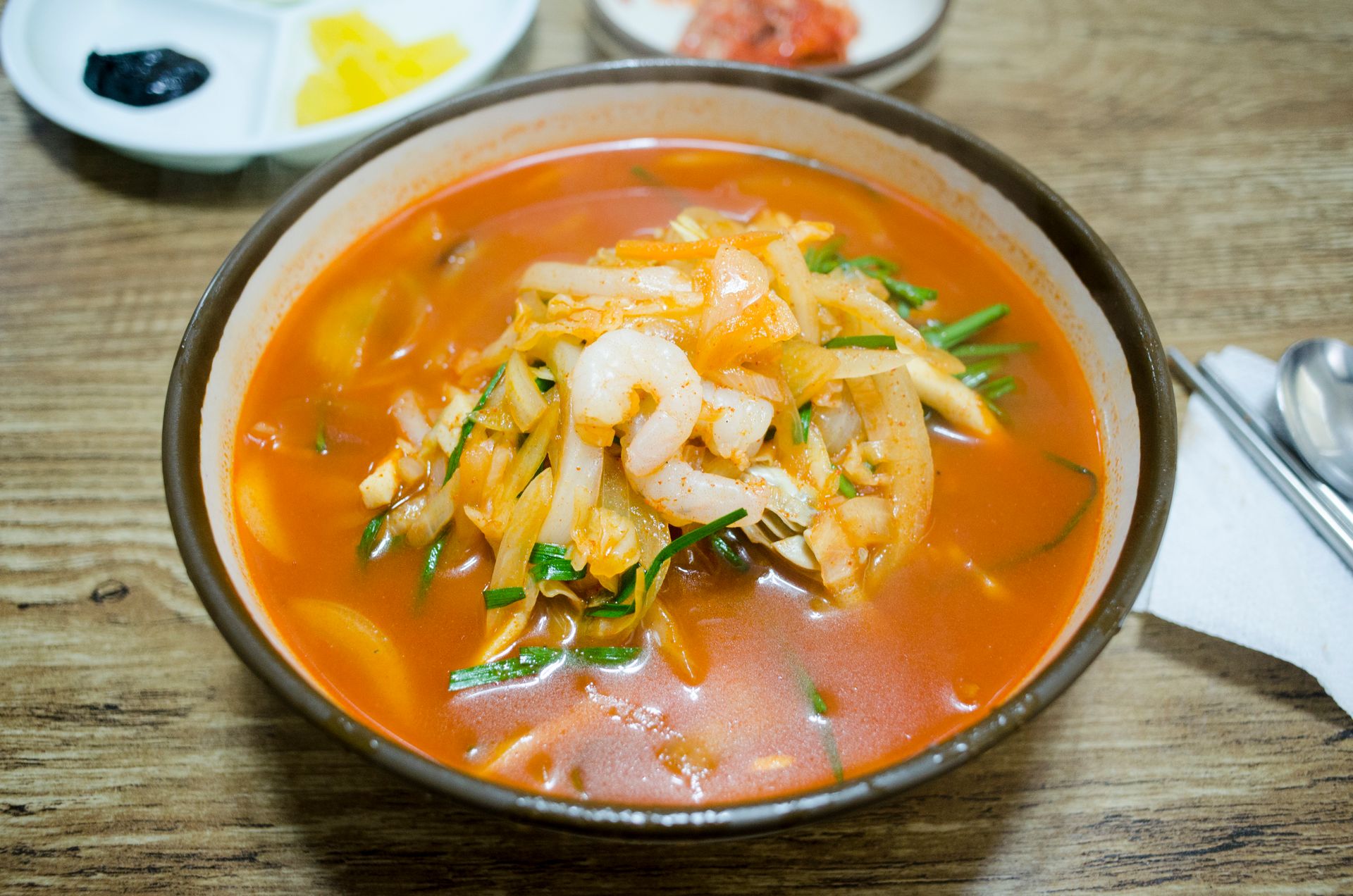 Delicious shrimp soup with vegetables in a ceramic bowl, perfect for food photography.