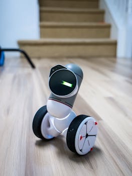 Close-up of a cutting-edge wheeled robot toy with soft focus background indoors.